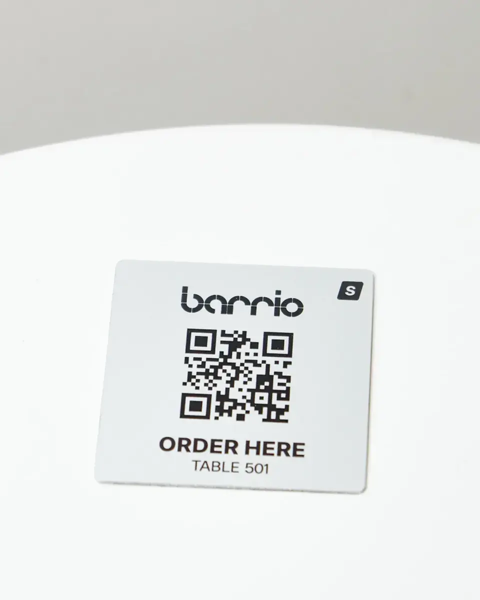 Brushed silver aluminium square for Barrio with a QR code to order