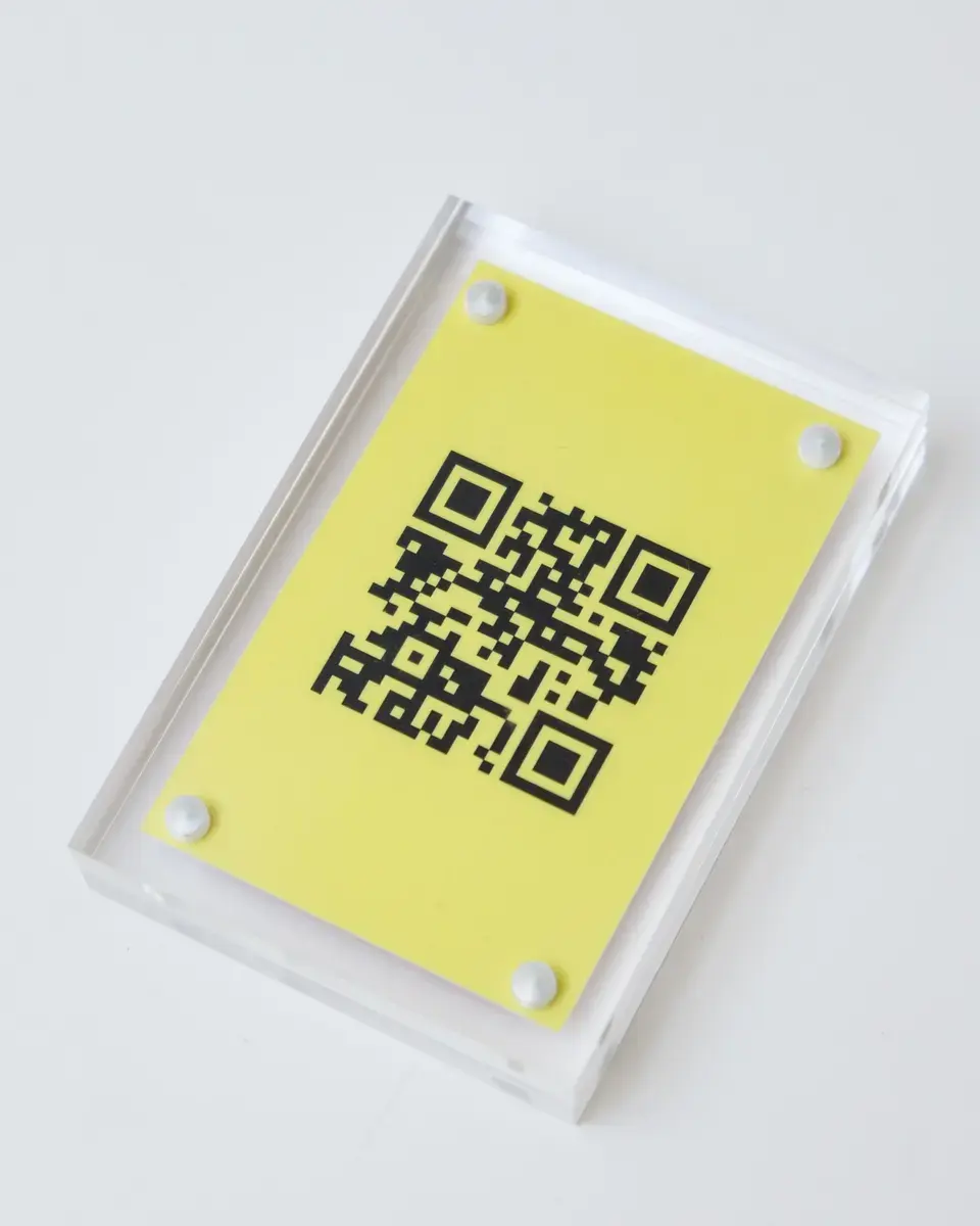 Clear magnetic acrylic block holding a yellow QR code card