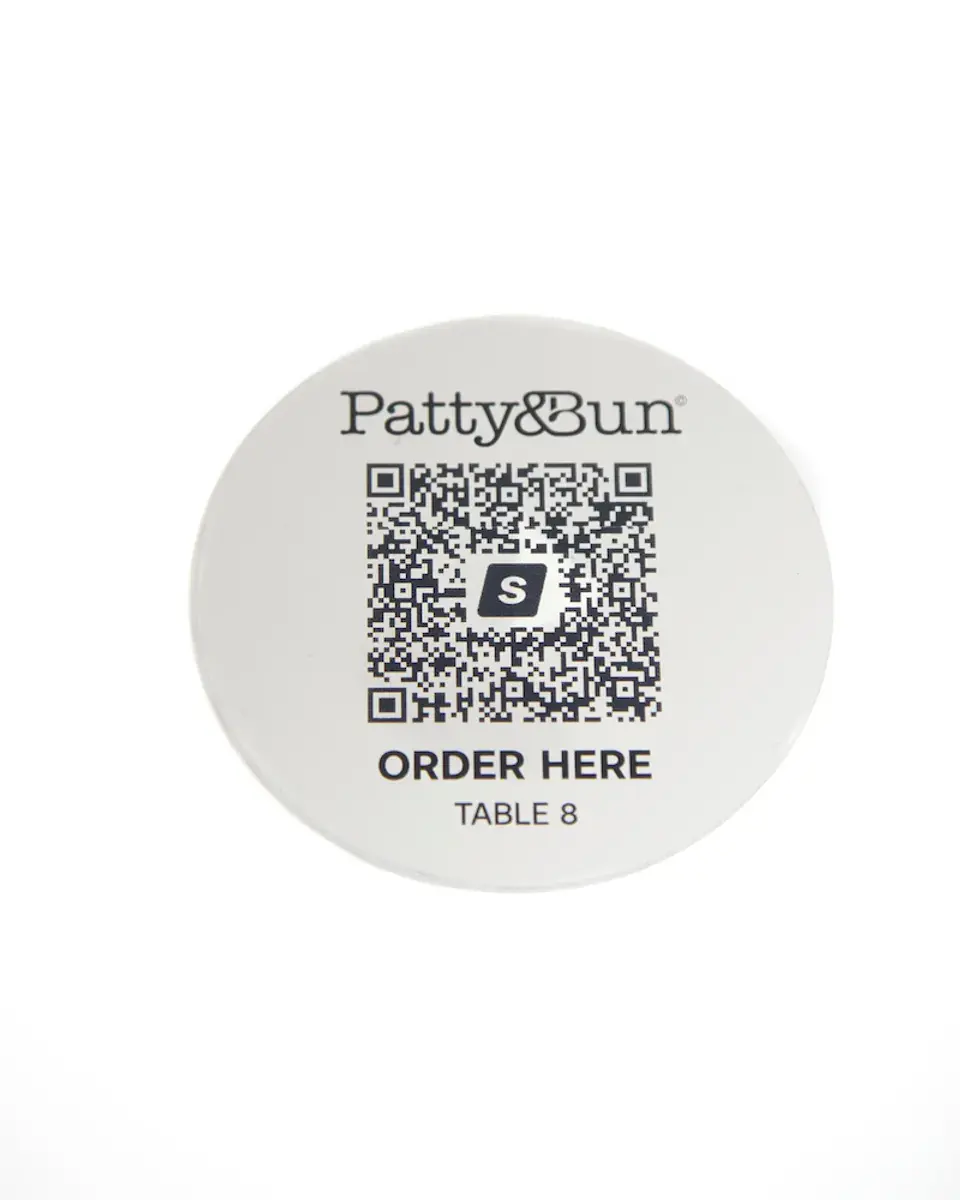 Small brushed silver aluminium disc for Patty & Bun with a QR code