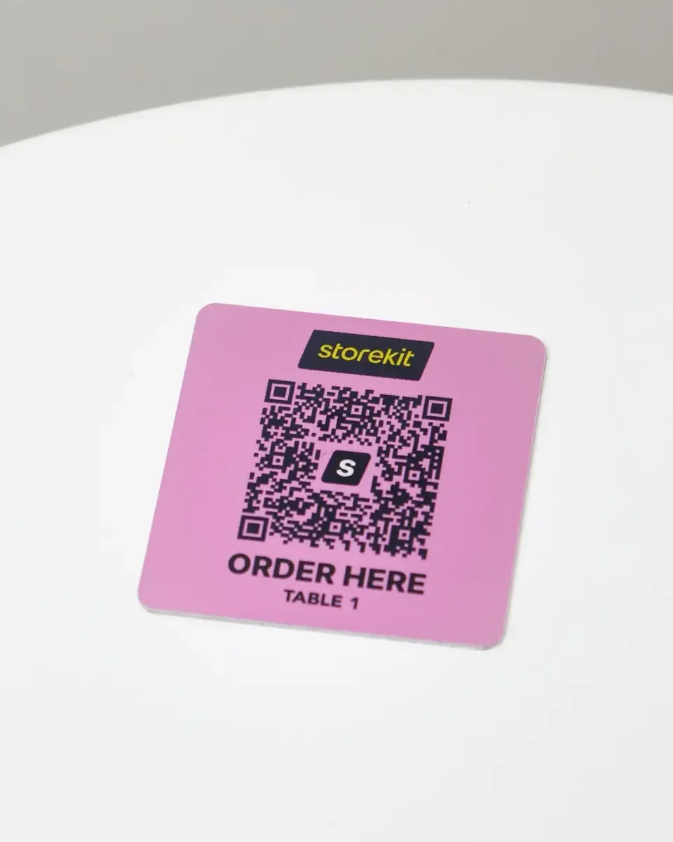 Pink aluminium square with a QR code and 'Order here'