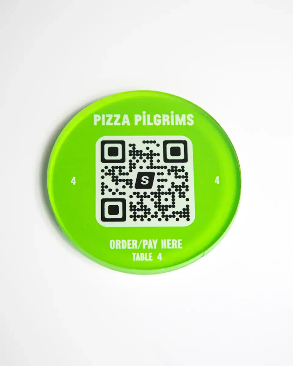 Lime green Perspex disc for Pizza Pilgrims with a QR code to order and pay